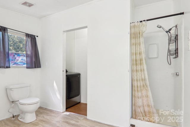 85 Star Flower Rd, Alexander, NC 28701 - bathroom featuring washer / clothes dryer, toilet, wood finished floors, and a shower with shower curtain