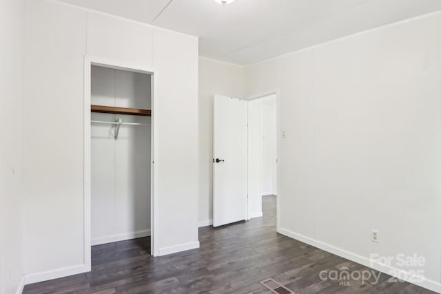 85 Star Flower Rd, Alexander, NC 28701 - unfurnished bedroom with dark wood-type flooring, a closet, and baseboards