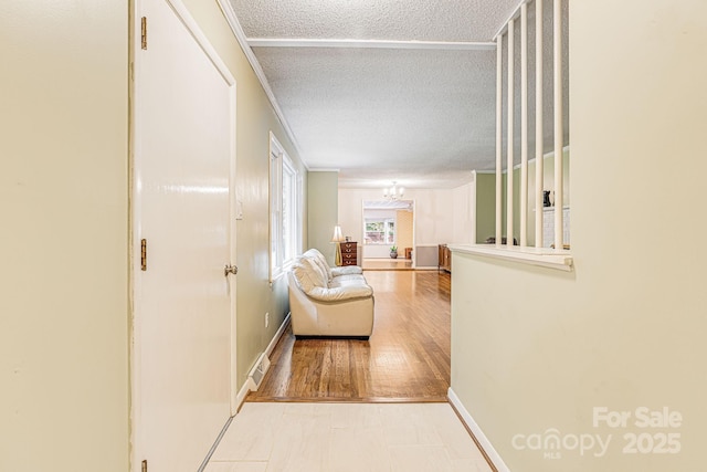 38 Westridge Dr, Asheville, NC 28803 - corridor featuring a textured ceiling, baseboards, crown molding, and a chandelier