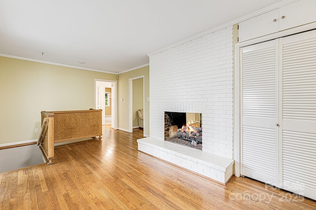 38 Westridge Dr, Asheville, NC 28803 - unfurnished living room featuring light wood-type flooring, a brick fireplace, ornamental molding, and baseboards
