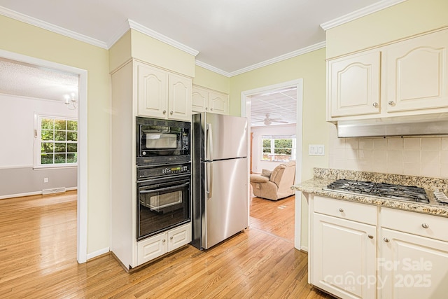 38 Westridge Dr, Asheville, NC 28803 - kitchen featuring black appliances, light wood finished floors, tasteful backsplash, plenty of natural light, and ornamental molding