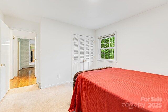 38 Westridge Dr, Asheville, NC 28803 - bedroom featuring light colored carpet, baseboards, and a closet