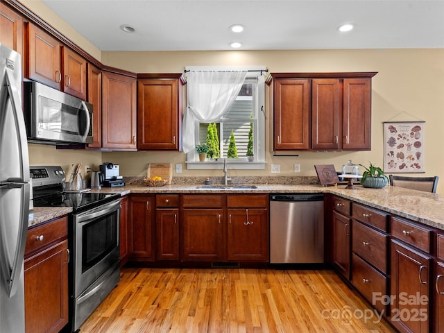 7 Oakhaven Ter, Asheville, NC 28803 - kitchen with stainless steel appliances, a sink, light wood-style flooring, light stone counters, and recessed lighting