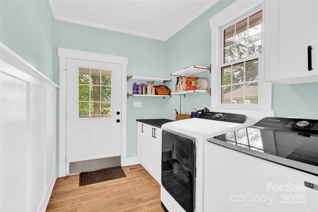 832 Kemp Rd, Mooresville, NC 28117 - washroom with cabinet space, washer and dryer, crown molding, and light wood-style floors