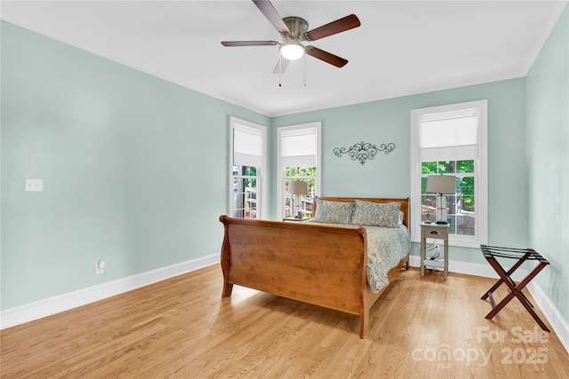 832 Kemp Rd, Mooresville, NC 28117 - bedroom featuring multiple windows, wood finished floors, crown molding, and ceiling fan
