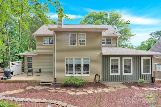 832 Kemp Rd, Mooresville, NC 28117 - rear view of house with a chimney, a wooden deck, board and batten siding, and roof with shingles