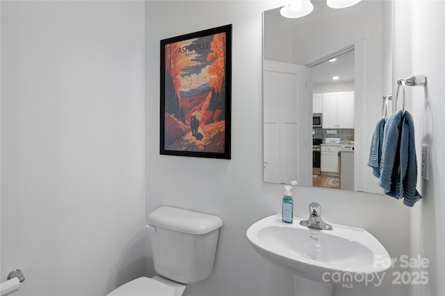 212 Rockrose Ct, Asheville, NC 28803 - bathroom featuring a sink, toilet, and backsplash