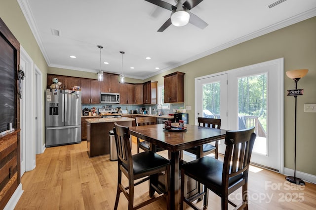 226 Stockwood Ln, Stanley, NC 28164 - dining space featuring light wood-style floors, ceiling fan, recessed lighting, and crown molding
