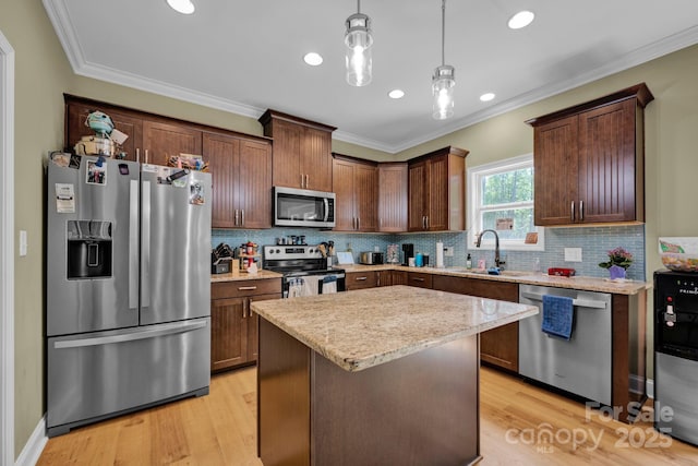 226 Stockwood Ln, Stanley, NC 28164 - kitchen with appliances with stainless steel finishes, a sink, ornamental molding, tasteful backsplash, and hanging light fixtures
