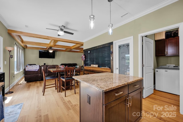 226 Stockwood Ln, Stanley, NC 28164 - kitchen featuring washer / dryer, coffered ceiling, light wood-style floors, open floor plan, and pendant lighting