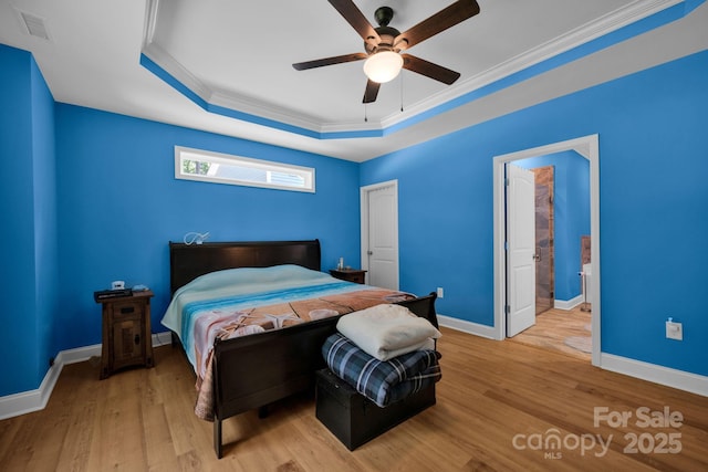 226 Stockwood Ln, Stanley, NC 28164 - bedroom with a raised ceiling, wood finished floors, baseboards, ornamental molding, and ceiling fan