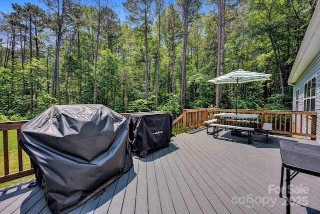 226 Stockwood Ln, Stanley, NC 28164 - deck featuring outdoor dining space, area for grilling, and a view of trees