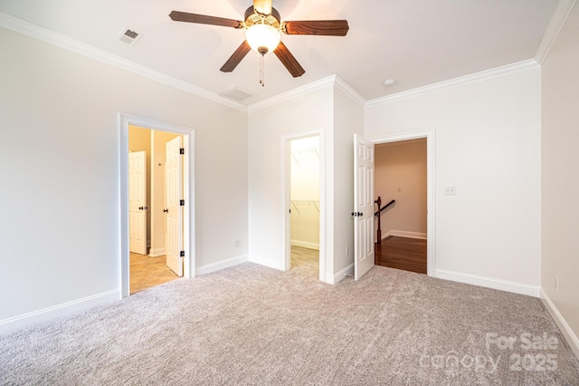 4431 1st Street Dr NW, Hickory, NC 28601 - unfurnished bedroom with crown molding, light carpet, a walk in closet, baseboards, and ceiling fan