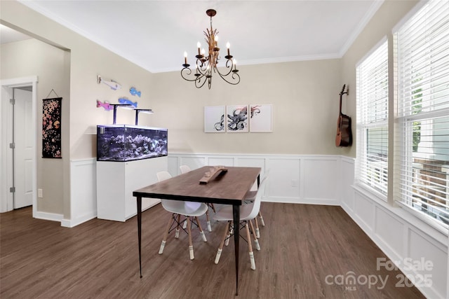 2210 Winding River Dr, Charlotte, NC 28214 - dining area with dark wood-style flooring, a chandelier, ornamental molding, wainscoting, and a decorative wall