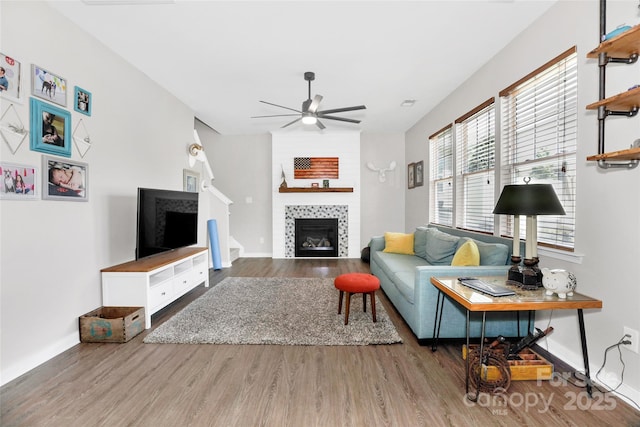 2210 Winding River Dr, Charlotte, NC 28214 - living area with a tiled fireplace, a ceiling fan, wood finished floors, and baseboards