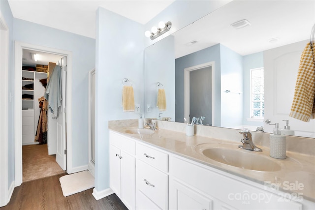 2210 Winding River Dr, Charlotte, NC 28214 - full bathroom with wood finished floors, double vanity, a spacious closet, and a shower stall