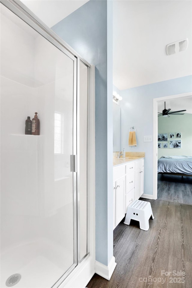 2210 Winding River Dr, Charlotte, NC 28214 - bathroom featuring ensuite bath, a shower stall, vanity, wood finished floors, and baseboards