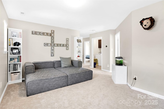 2210 Winding River Dr, Charlotte, NC 28214 - living area featuring carpet, washer / clothes dryer, and baseboards