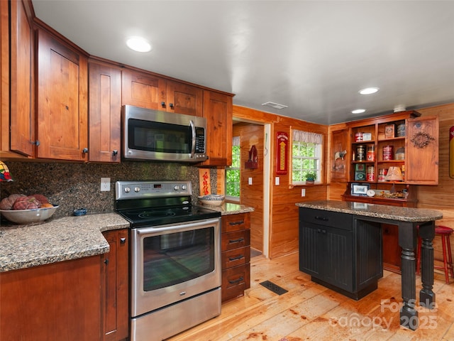 229 Crabtree Mountain Rd, Canton, NC 28716 - kitchen with appliances with stainless steel finishes, light wood finished floors, tasteful backsplash, brown cabinetry, and recessed lighting