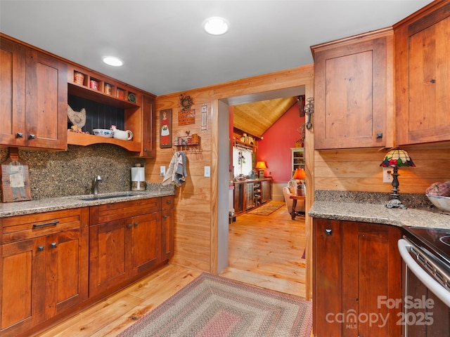 229 Crabtree Mountain Rd, Canton, NC 28716 - kitchen featuring a sink, light wood-style floors, tasteful backsplash, vaulted ceiling, and light stone counters