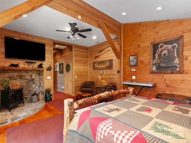 229 Crabtree Mountain Rd, Canton, NC 28716 - bedroom with wooden walls, a wood stove, wood finished floors, and recessed lighting