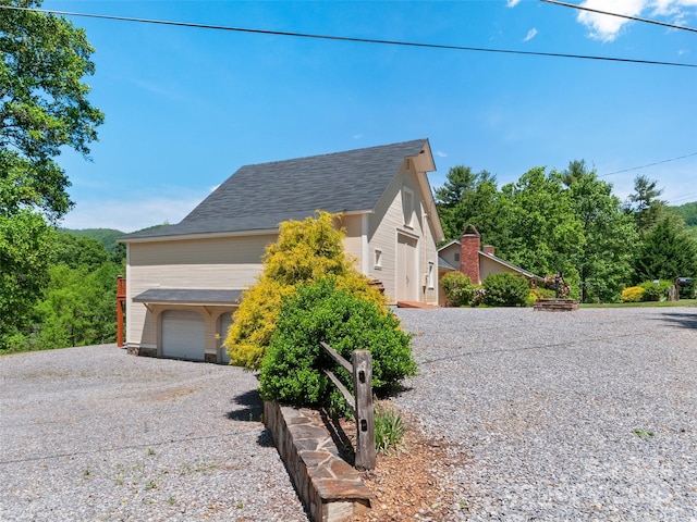 229 Crabtree Mountain Rd, Canton, NC 28716 - view of front of house featuring gravel driveway, roof with shingles, and an attached garage