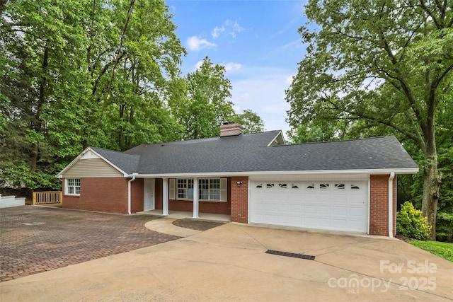 34 Westridge Dr, Asheville, NC 28803 - view of front facade with driveway, brick siding, a garage, and a shingled roof