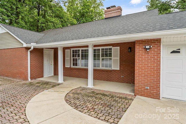 34 Westridge Dr, Asheville, NC 28803 - entrance to property with a shingled roof, brick siding, a chimney, and covered porch