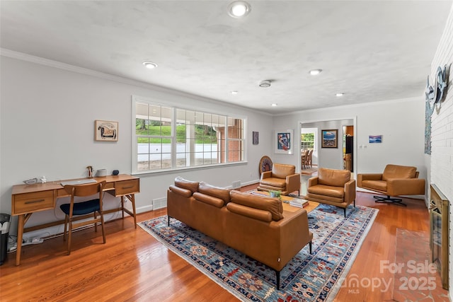 34 Westridge Dr, Asheville, NC 28803 - living room featuring healthy amount of natural light, crown molding, wood finished floors, a fireplace, and baseboards