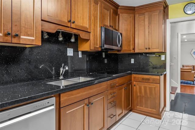 34 Westridge Dr, Asheville, NC 28803 - kitchen with appliances with stainless steel finishes, light tile patterned floors, brown cabinetry, and a sink