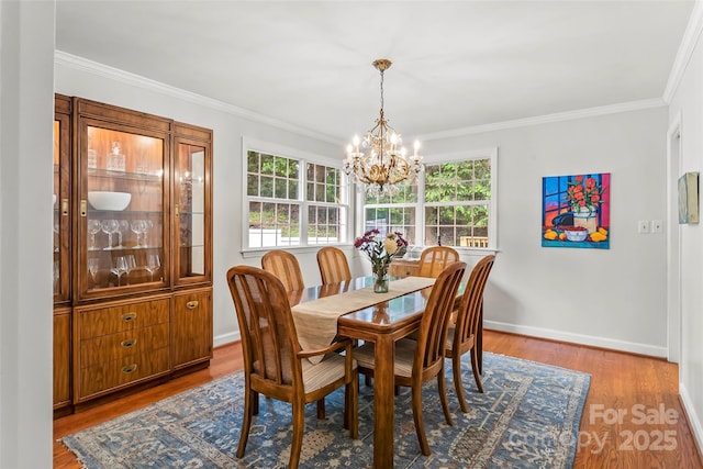 34 Westridge Dr, Asheville, NC 28803 - dining space with a chandelier, plenty of natural light, wood finished floors, ornamental molding, and baseboards