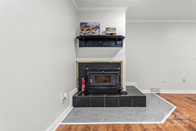 34 Westridge Dr, Asheville, NC 28803 - detailed view of a wood stove, a fire extinguisher, wood finished floors, ornamental molding, and baseboards