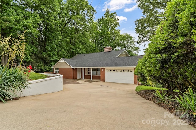 34 Westridge Dr, Asheville, NC 28803 - view of front of property with brick siding, driveway, a garage, a chimney, and roof with shingles