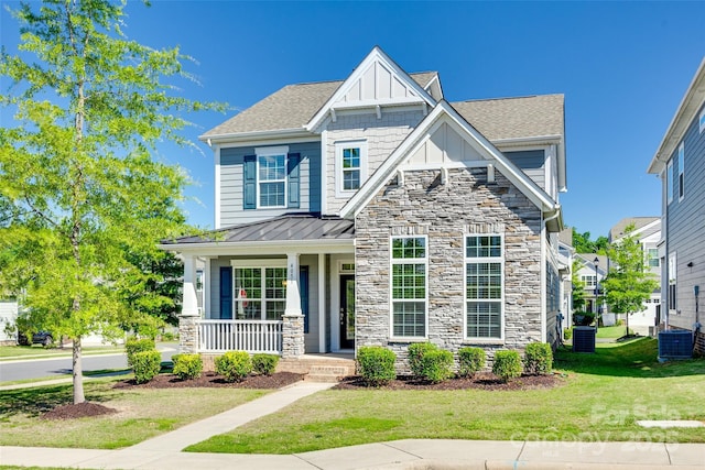 4051 Whittier Ln, Fort Mill, SC 29708 - craftsman house with stone siding, a porch, central AC, and a front lawn