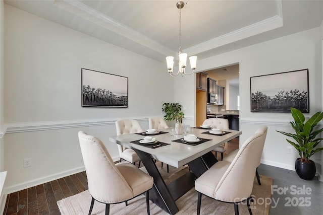 4051 Whittier Ln, Fort Mill, SC 29708 - dining space featuring a chandelier, wood finished floors, a tray ceiling, crown molding, and baseboards