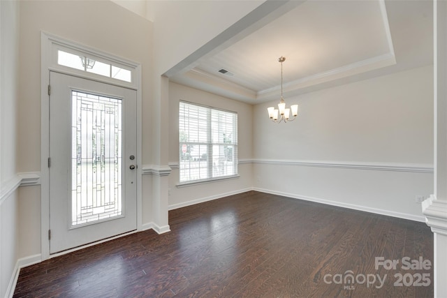 4051 Whittier Ln, Fort Mill, SC 29708 - foyer entrance featuring a raised ceiling, a chandelier, dark wood-style flooring, crown molding, and baseboards