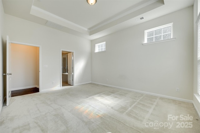 4051 Whittier Ln, Fort Mill, SC 29708 - unfurnished bedroom featuring a tray ceiling, carpet flooring, ornamental molding, baseboards, and connected bathroom