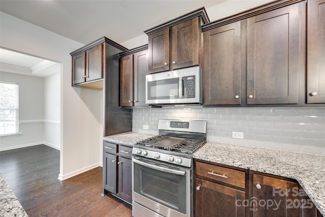 4051 Whittier Ln, Fort Mill, SC 29708 - kitchen with appliances with stainless steel finishes, baseboards, dark brown cabinets, dark wood finished floors, and light stone countertops