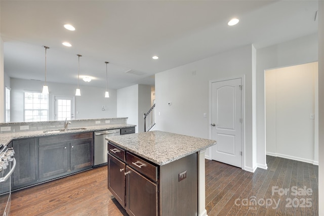 4051 Whittier Ln, Fort Mill, SC 29708 - kitchen with stainless steel dishwasher, a sink, dark wood-style floors, light stone counters, and recessed lighting