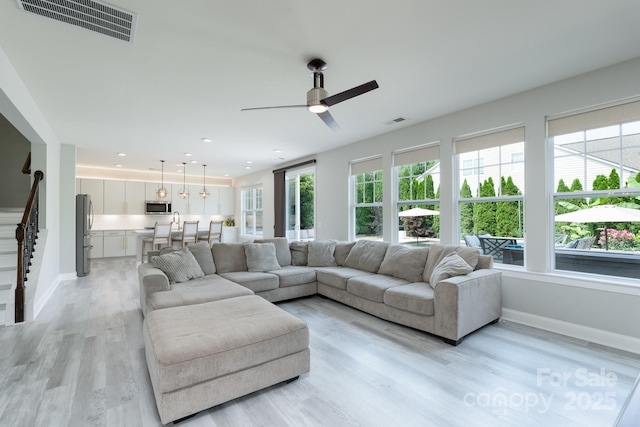 1211 Gold Rush Ct, Fort Mill, SC 29708 - living area with light wood-type flooring, a ceiling fan, baseboards, recessed lighting, and stairs