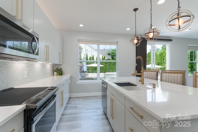 1211 Gold Rush Ct, Fort Mill, SC 29708 - kitchen featuring stainless steel appliances, a sink, recessed lighting, decorative backsplash, and light countertops