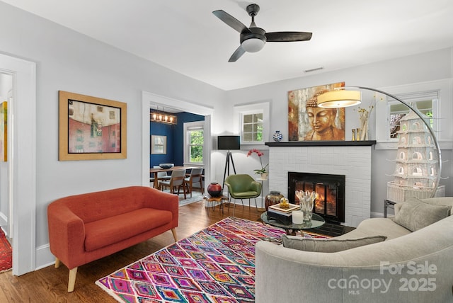 140 Pennsylvania Ave, Asheville, NC 28806 - living area with wood finished floors, a brick fireplace, ceiling fan, and baseboards