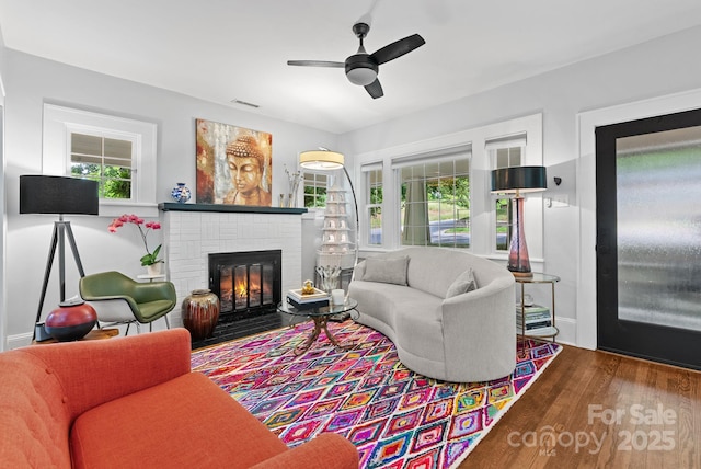 140 Pennsylvania Ave, Asheville, NC 28806 - living room featuring wood finished floors, plenty of natural light, a ceiling fan, and a brick fireplace