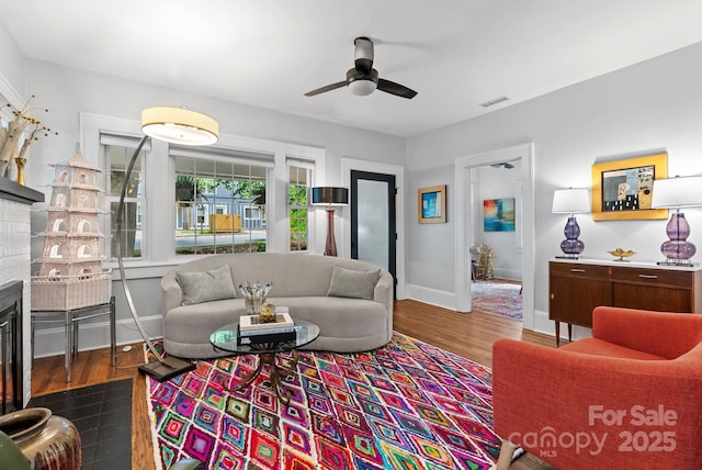 140 Pennsylvania Ave, Asheville, NC 28806 - living room featuring a glass covered fireplace, dark wood-type flooring, baseboards, and a ceiling fan