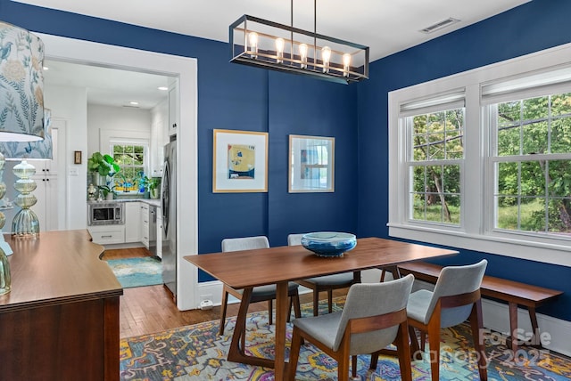 140 Pennsylvania Ave, Asheville, NC 28806 - dining room featuring wood finished floors and a chandelier