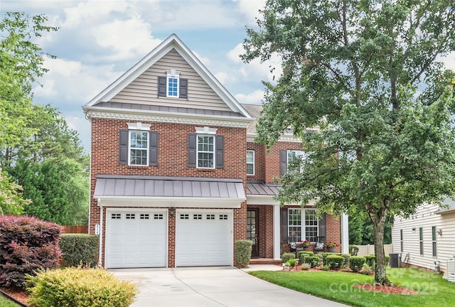 8115 Wilburn Ct, Charlotte, NC 28277 - view of front facade featuring a standing seam roof, concrete driveway, brick siding, a garage, and metal roof