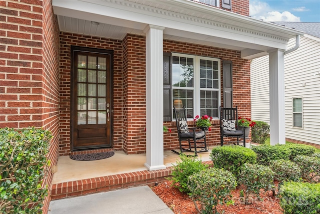 8115 Wilburn Ct, Charlotte, NC 28277 - doorway to property with covered porch and brick siding