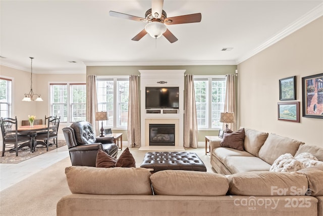 8115 Wilburn Ct, Charlotte, NC 28277 - living room featuring ornamental molding, ceiling fan, a fireplace with flush hearth, and a chandelier