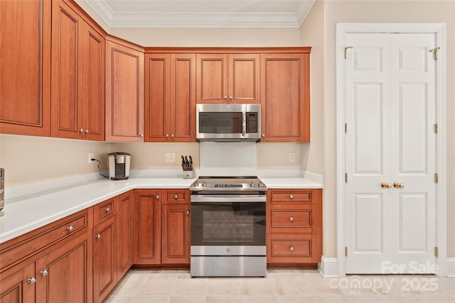 8115 Wilburn Ct, Charlotte, NC 28277 - kitchen featuring stainless steel appliances, brown cabinets, and crown molding