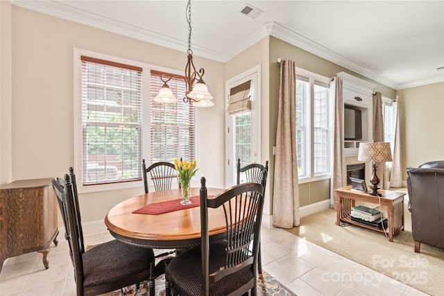8115 Wilburn Ct, Charlotte, NC 28277 - dining area featuring light tile patterned floors, ornamental molding, baseboards, light colored carpet, and a chandelier